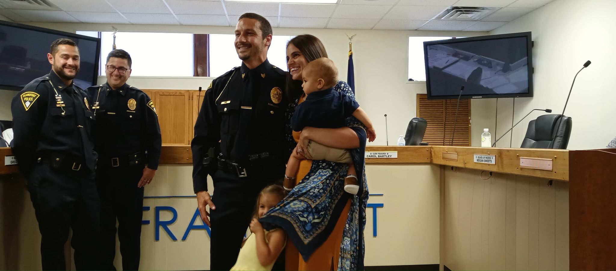 Sergeant Brett Dale stands with family after being promoted to Sergeant